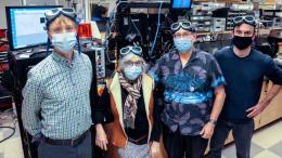 4 people in laboratory wearing masks and goggles