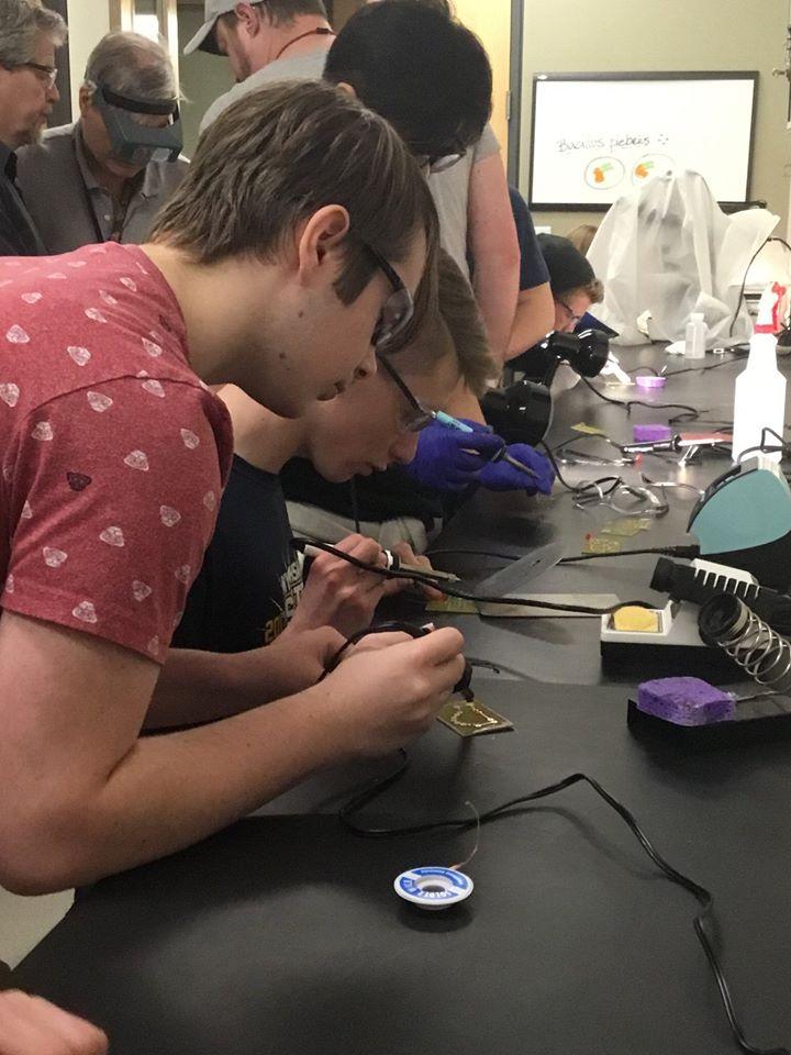 Students working at lab bench with soldering irons