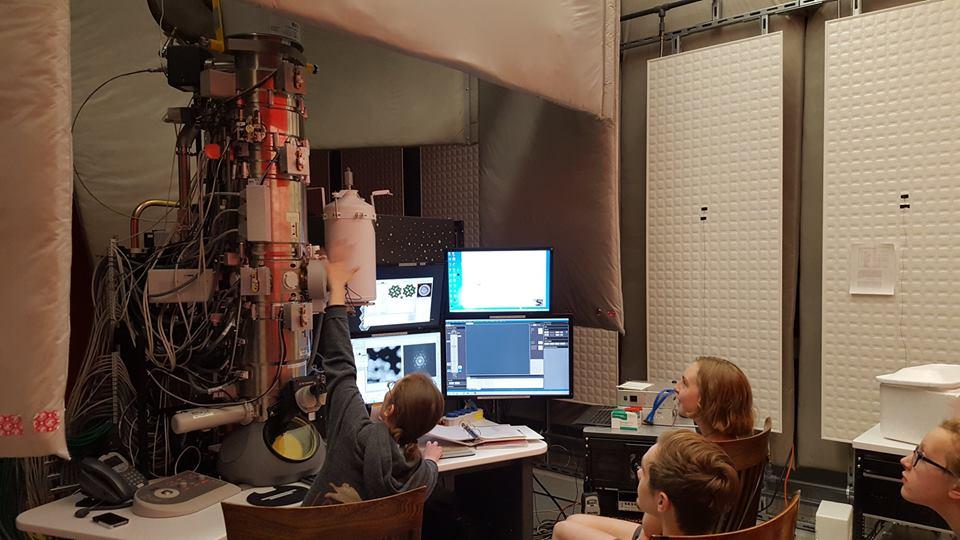 Students attending a demonstration of an electron microscope