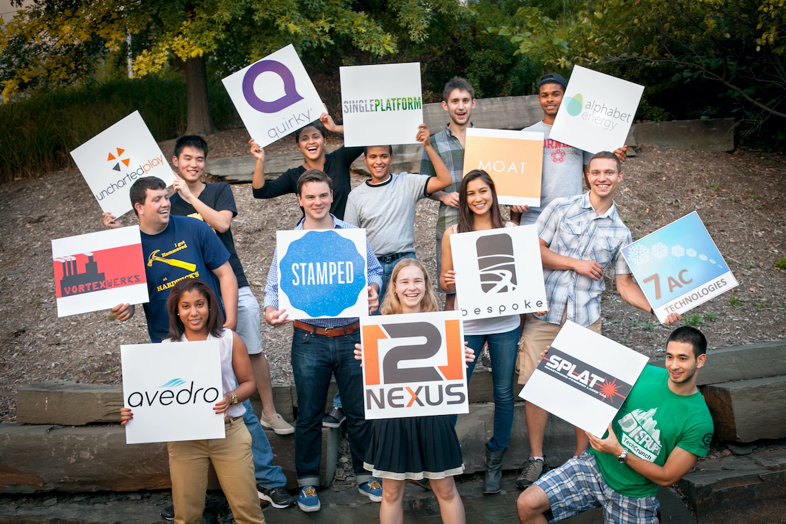 student hold signs with company logos