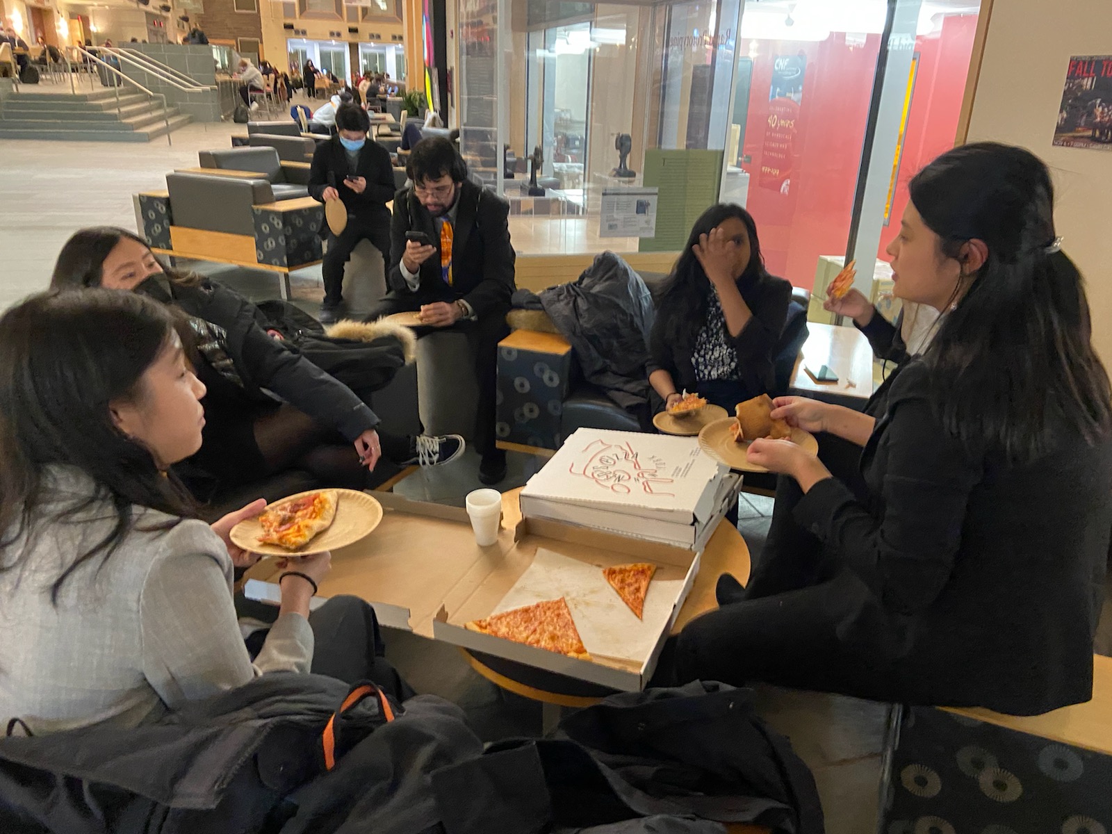 student eating pizza